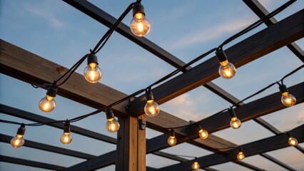 A closeup shot of a robust string light system strung between construction beams with several bulbs glowing against a twilight sky enhancing the ambiance while providing essential