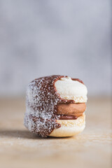 French macaroon with chocolate cream and coconut filling.