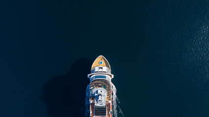 Aerial view of luxurious cruise ship sailing cutting through the ocean waters, maritime lifestyle