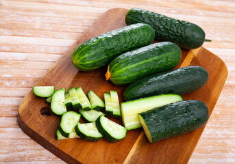 Ripe juicy cucumbers on a wooden table closeup
