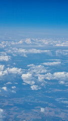 View of the white clouds and Earth from the airplane porthole. Travel concept