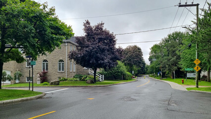 Private houses in Montreal, Canada - july 2023 : Front view of a pretty house surrounded by trees