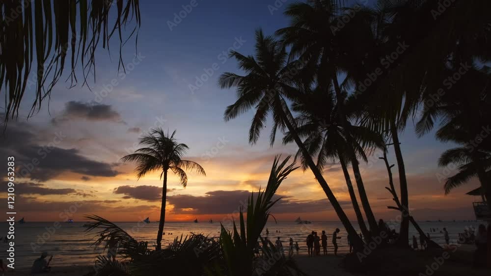 Wall mural silhouetted people and palms near sea. sunset at tropical white beach, boracay island, philippines, 