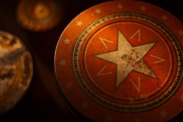 Closeup of a retro metal lid with a white star on it.  