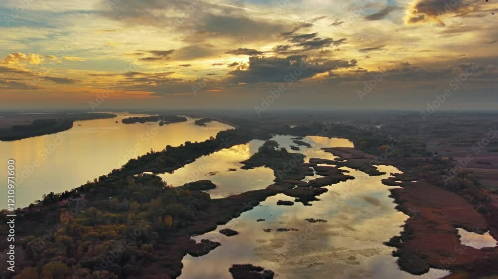 Wall mural aerial view landscape with beautiful sunset with dramatic sky reflection on danube river, 4k