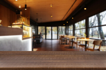 Empty wooden table in restaurant, space for design