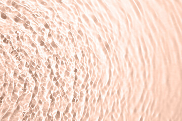 Rippled surface of clear water on beige background, top view. Mocha mousse - color of 2025 year