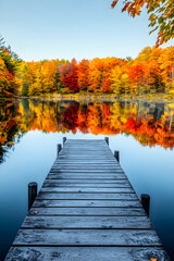 Serene Lakeside Scene: Tranquil Autumn Reflections with Vibrant Fall Colors and Wooden Pier