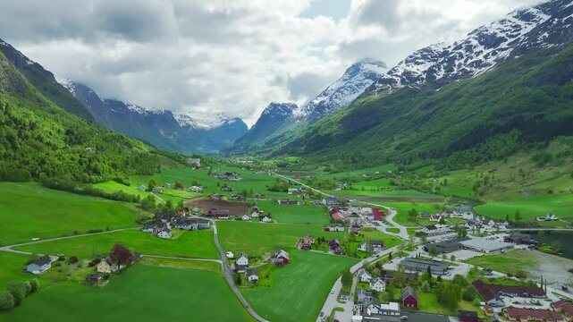 Mountains and Fiord in the clouds over Village from a drone, Olden, Innvikfjorden, Norway