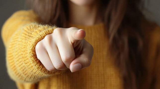 Individual points directly at the viewer, emphasizing a call to action or engagement in a cozy indoor setting