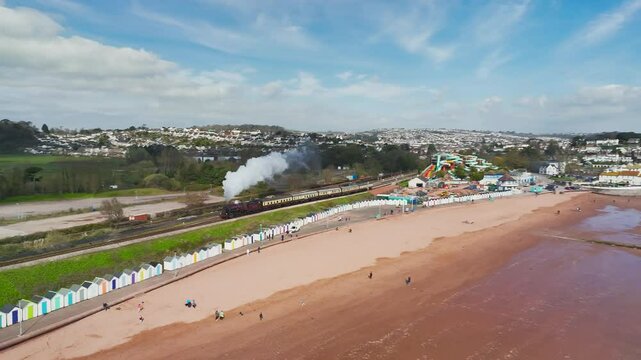 Steam Train over Goodrington Beach from a drone, Paignton, Kingswear, Devon, England