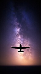 A silhouette of an airplane flying through a starry night sky filled with vibrant colors of the Milky Way galaxy.