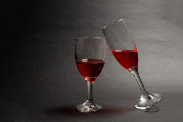 Two glasses of red wine on black paper, Two glasses of wine side by side. Valentine's day concept background