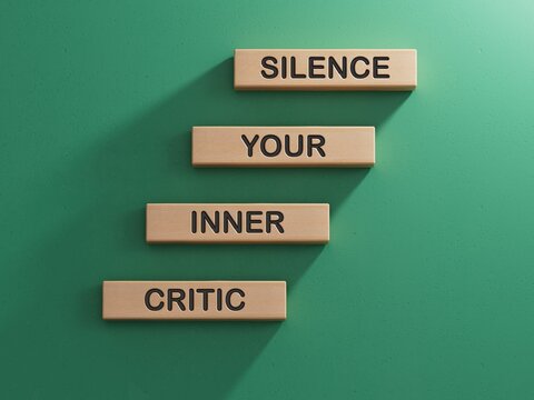 Silence your inner critic symbol. Wooden blocks with words Silence your inner critic.Business and Silence your inner critic concept.3D rendering on green background.