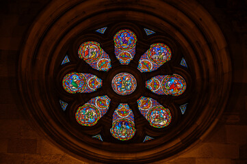 A circular stained-glass window depicting the life of Saint Vincent of Saragossa. Cathedral of Saint Mary Major (S&eacute; de Lisboa) in Lisbon, Portugal.