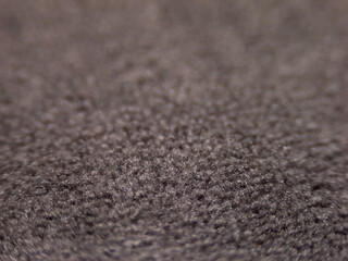 The image is a close up of a fuzzy, gray fabric