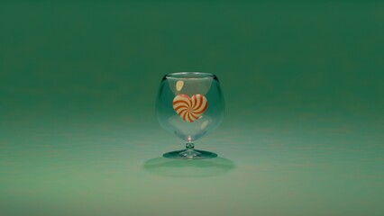 A transparent glass and red and white striped heart candies positioned on a clean background