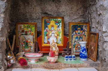 An altar with a Buddhist god outside a pagoda in Asia.