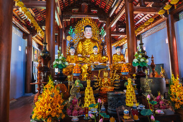 Fototapeta premium There are many Buddhist golden Buddha statues inside a temple in a pagoda in Nha Trang, Asia