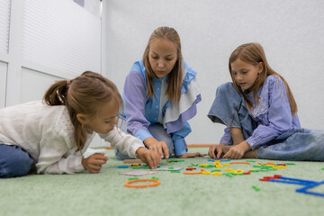 children with a teacher at a kindergarten class