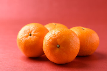 Mandarin tangerine orange fruit on red background, Lucky food in Lunar New Year or Chinese New Year