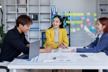Group of confident business people point to graphs and charts to analyze market data, balance sheet, account, net profit to plan new sales strategies to increase production capacity.	
