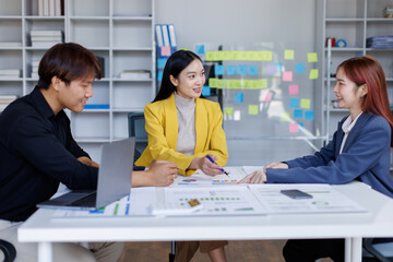 Group of confident business people point to graphs and charts to analyze market data, balance sheet, account, net profit to plan new sales strategies to increase production capacity.	
