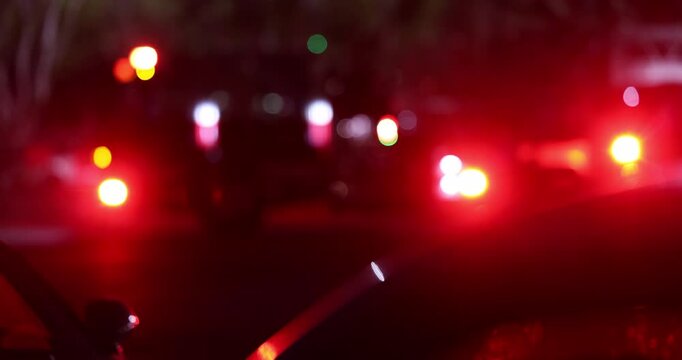 Abstracted blurred bokeh view of a fire engine responding to the scene of an emergency at night.