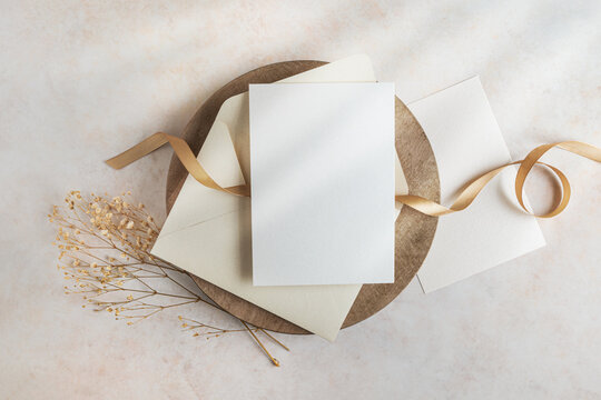 Two blank cards and envelope mockup with gold ribbon top view, sample stationery invitations