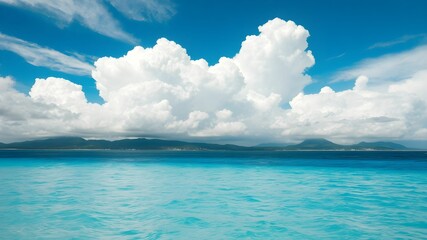 tropical beach with turquoise water and white clouds in the blue sky