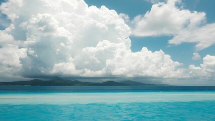 tropical beach with turquoise water and white clouds in the blue sky