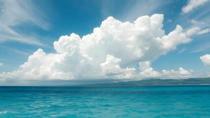 tropical beach with turquoise water and white clouds in the blue sky
