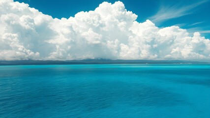 tropical beach with turquoise water and white clouds in the blue sky