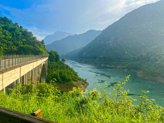 Valvestino lake and Recchi bridge on summer rainy day, Italy