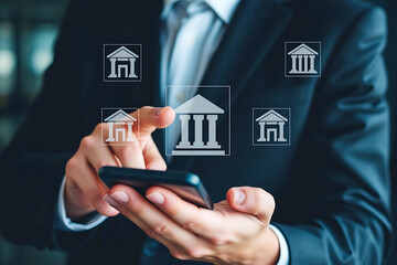 Person using a smartphone to access online banking services.  Multiple bank building icons appear on the screen, illustrating ease of mobile banking and financial management.