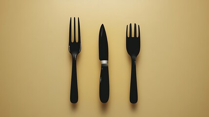 Black Forks and Knife on Beige Background