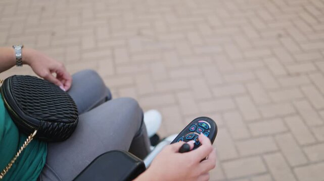 Woman using electric wheelchair control