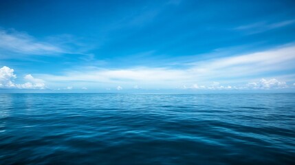 Fototapeta premium Serene ocean horizon under blue sky. Ideal for marine environments, natural landscapes, and peaceful scenes.