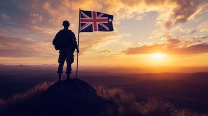 Silhouette of a soldier with flag standing at the peak of a hill during sunset