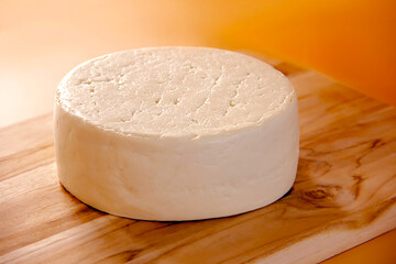 WHOLE FRESCAL MINAS CHEESE ON WOODEN BOARD WITH ISOLATED BACKGROUND - TRADITIONAL CHEESE FROM MINAS GERAIS