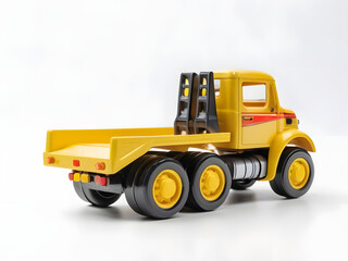 Fototapeta premium yellow dump truck toy on white background, yellow toy truck 