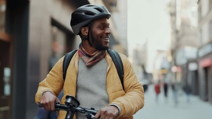 Joyful cyclist navigates city streets with helmet and backpack in urban setting
