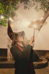 Man dressed in wizard attire performing magic in a whimsical garden at twilight