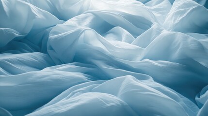Obraz premium A close-up of light blue fabric with soft folds, ideal for fashion, textiles, or interior design photography showcasing texture and elegance