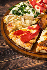 Assorted handmade Argentinian pizza on wooden background