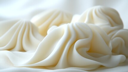 Close-up of creamy, swirled dessert on white fabric.