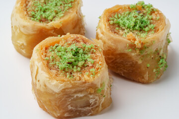 Delightful layers of baklava filled with nuts and topped with green pistachio garnish served at a dessert cafe