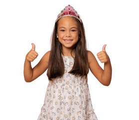 Happy child girl wearing a princess crown showing thumbs up isolated over transparent background....