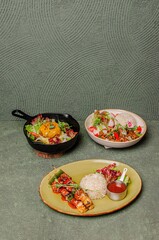 Beef Steak with Mozzarella Cheese and Salad in a Skillet, Beef Slices with Mushroom Sauce, Rice, and Salad in a Bowl, BBQ Beef with Sauce, Rice, and Salad on a Plate