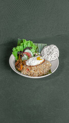 Fried Rice With Sunny Side Up Egg, Chicken, Vegetable Salad, And Crackers, Served On A White Plate, A Flavorful And Satisfying Dish.
